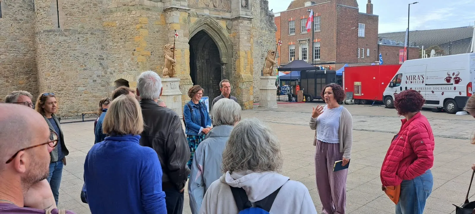 Guests listening to Kay outside the Bargate