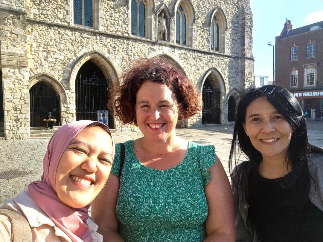 Kay and two guests smiling outside the Bargate