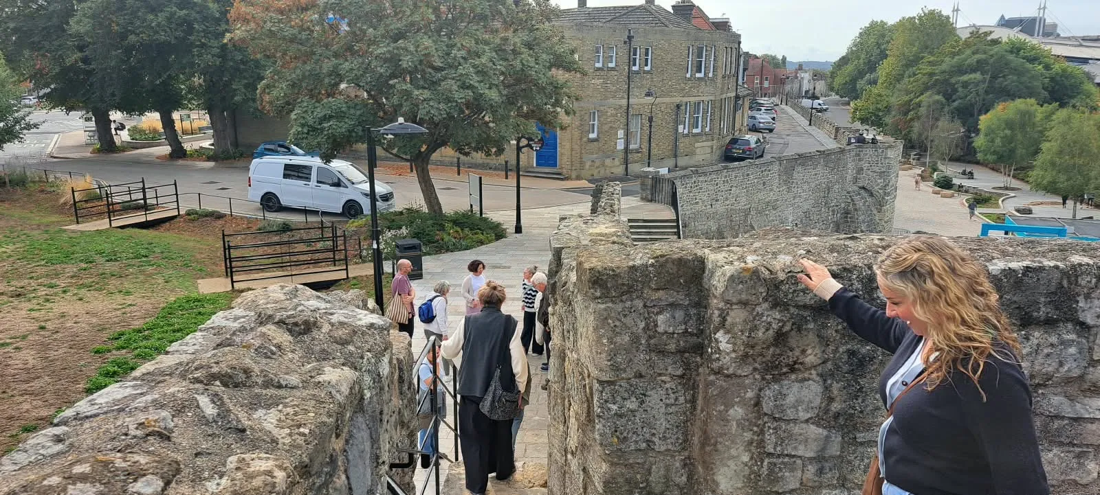 Tour guests walking down steps through Southampton's medieval walls